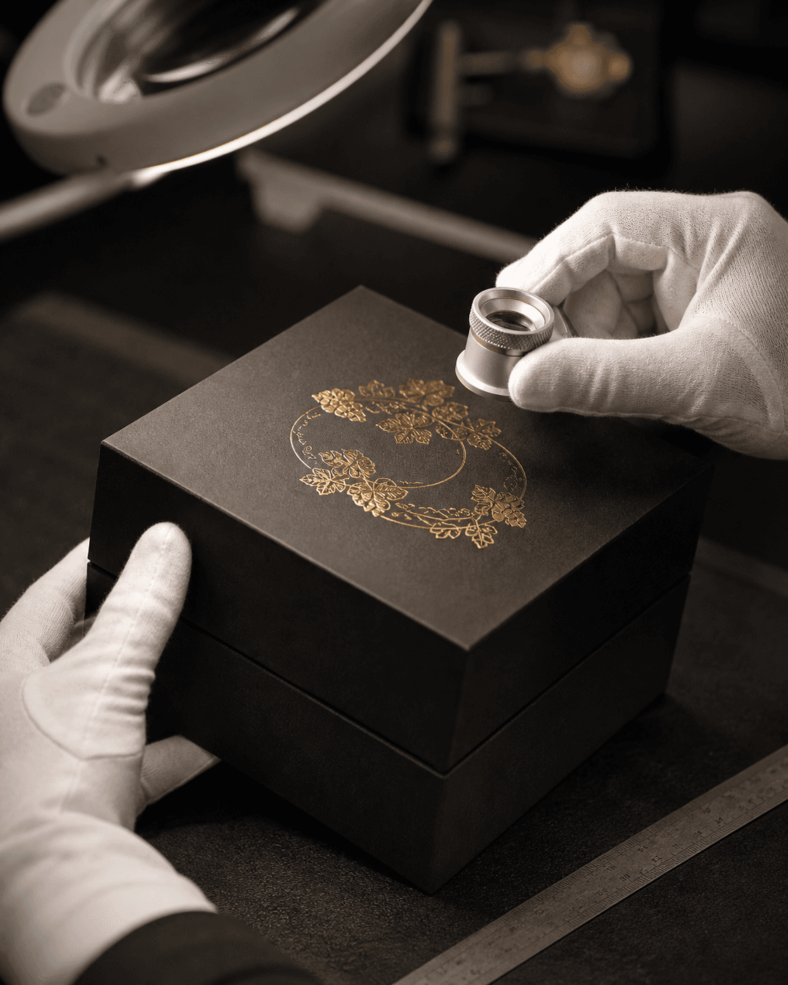 A Huamei craftsperson inspecting a premium paper box